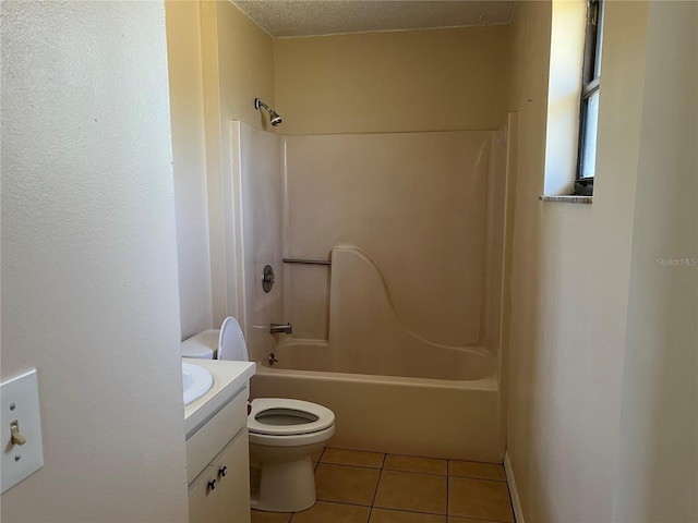 bathroom featuring toilet, tile patterned floors, bathing tub / shower combination, and vanity