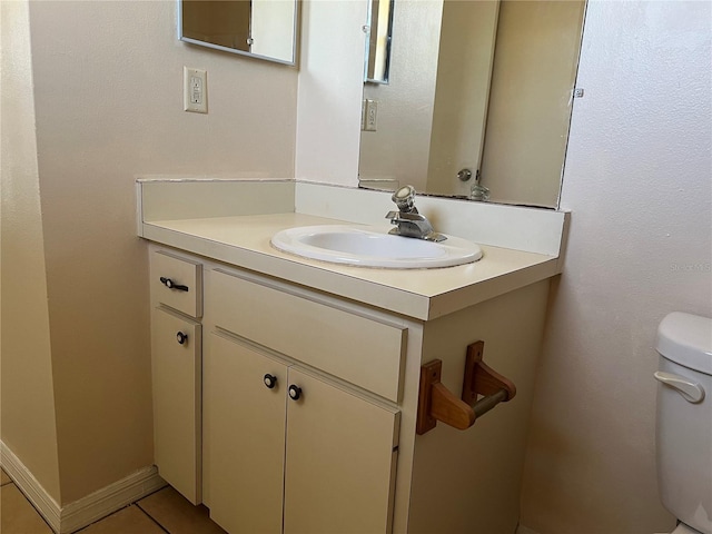 half bath featuring toilet, tile patterned flooring, and vanity