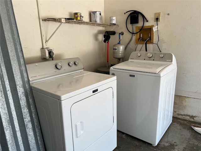 washroom featuring laundry area and washing machine and dryer