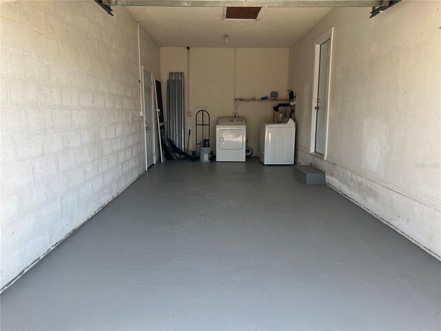 garage featuring washing machine and dryer