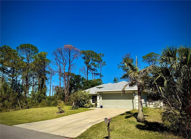 view of front facade with a front lawn, stucco siding, a garage, and concrete driveway