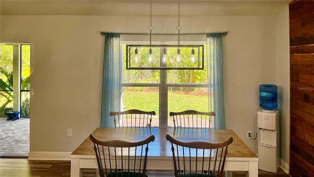 dining room featuring baseboards and dark wood-style floors