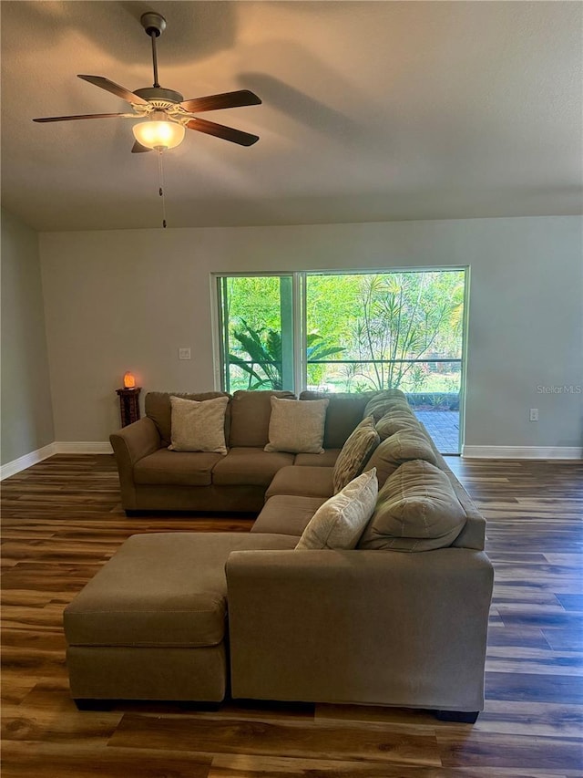 living room with wood finished floors, plenty of natural light, baseboards, and ceiling fan