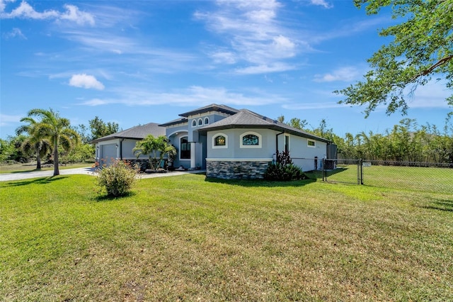 view of front of property with a garage, a front lawn, a gate, and concrete driveway