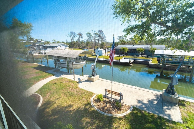 view of dock featuring boat lift, a yard, and a water view