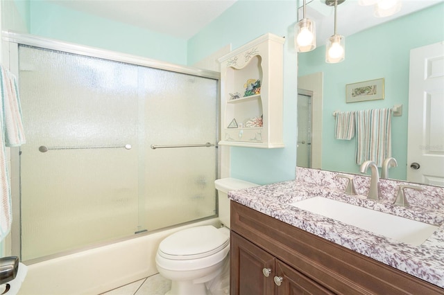 bathroom featuring tile patterned flooring, toilet, vanity, and bath / shower combo with glass door