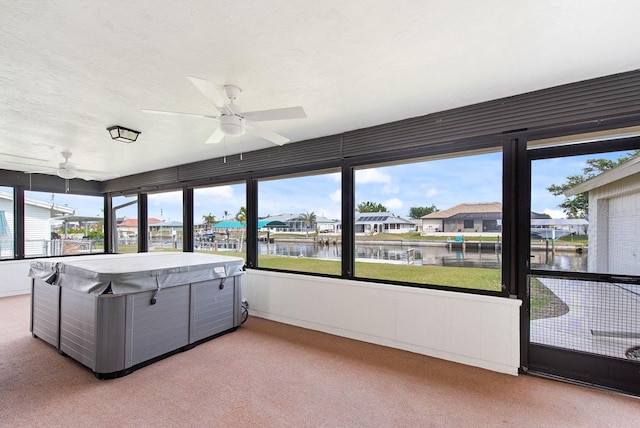 5266 Cooper Ter, Port Charlotte, FL 33981 - sunroom with a hot tub, ceiling fan, a water view, and carpet floors