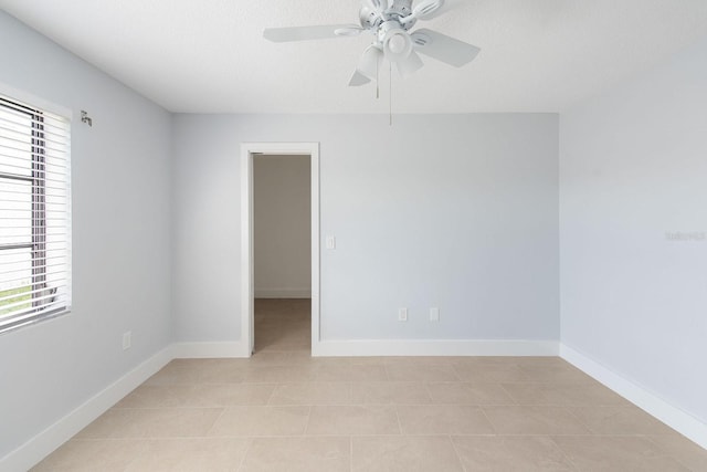 5266 Cooper Ter, Port Charlotte, FL 33981 - empty room featuring plenty of natural light, light tile patterned floors, and ceiling fan