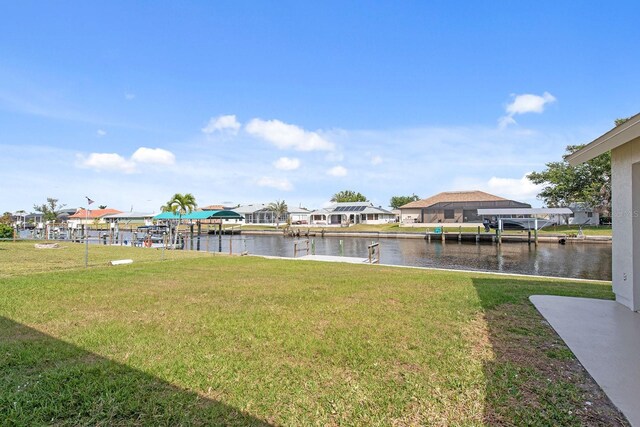 5266 Cooper Ter, Port Charlotte, FL 33981 - view of green lawn featuring a water view, a boat dock, and a residential view