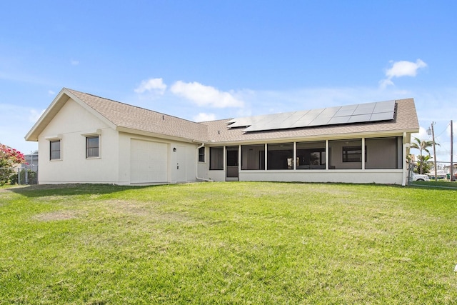 5266 Cooper Ter, Port Charlotte, FL 33981 - rear view of property featuring a sunroom, roof mounted solar panels, a lawn, and a garage