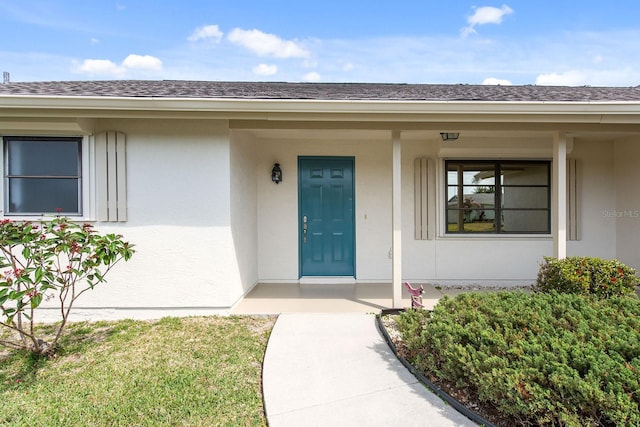 5266 Cooper Ter, Port Charlotte, FL 33981 - entrance to property featuring stucco siding, roof with shingles, and covered porch