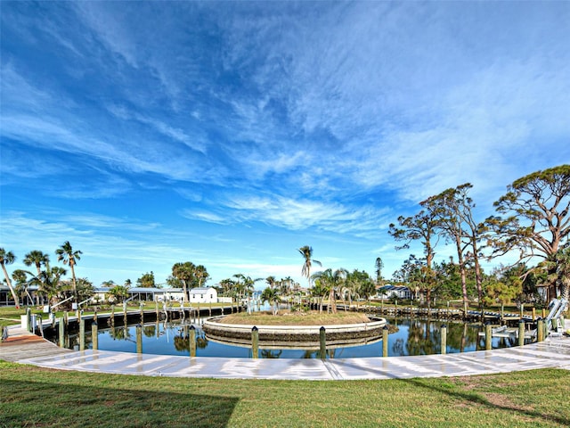 view of dock with a water view and a yard