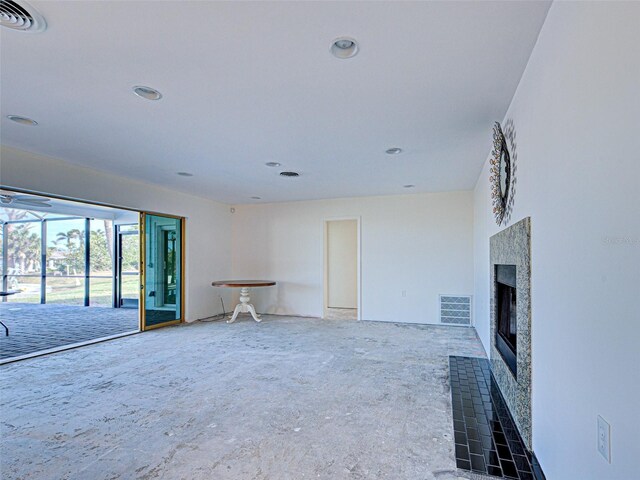 unfurnished living room with recessed lighting, a fireplace, and visible vents