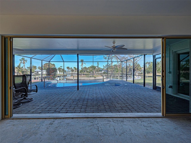 exterior space featuring an outdoor pool, glass enclosure, and ceiling fan