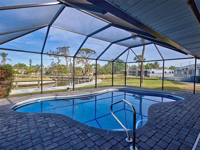 outdoor pool with a water view, glass enclosure, a patio, and a lawn