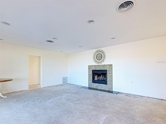 unfurnished living room featuring a high end fireplace, visible vents, and recessed lighting
