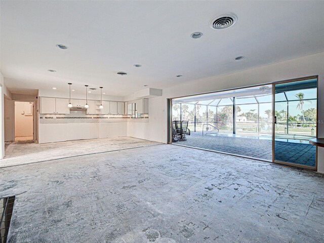 unfurnished living room featuring visible vents, recessed lighting, and a sunroom
