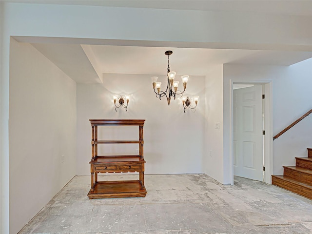 unfurnished dining area featuring an inviting chandelier and stairs