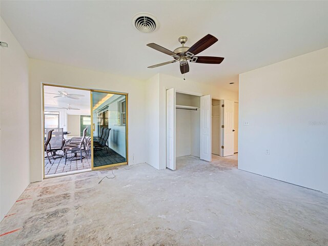 unfurnished bedroom with two closets, ceiling fan, unfinished concrete flooring, and visible vents