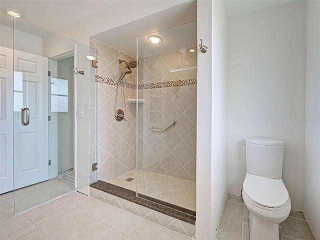 full bath with a shower stall, tile patterned flooring, toilet, and recessed lighting