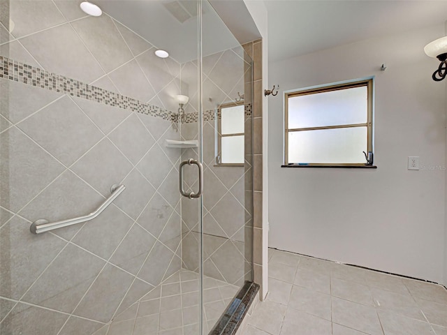 full bathroom with a stall shower and tile patterned flooring