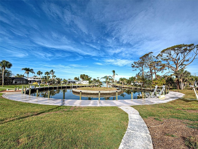 view of dock with a lawn