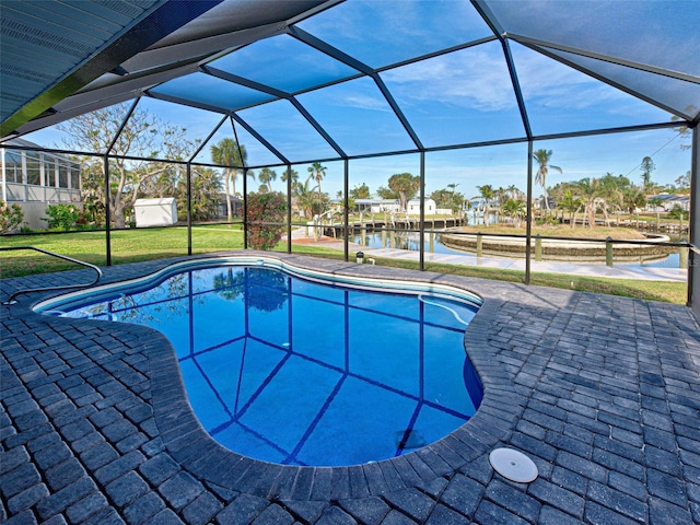 pool with a water view, glass enclosure, a patio, and a lawn