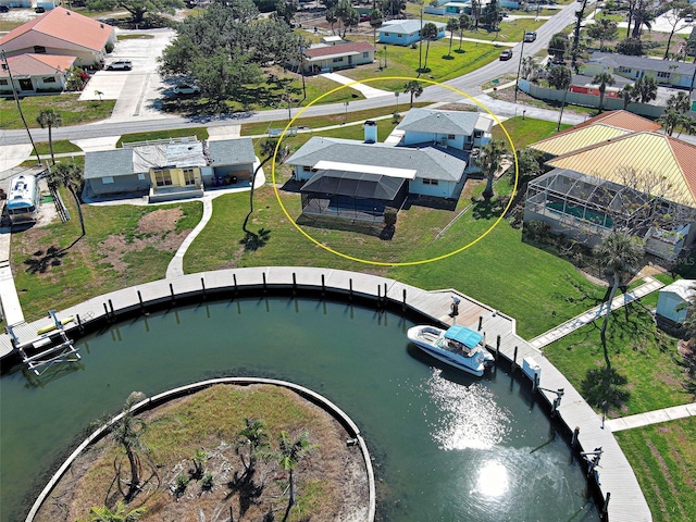 drone / aerial view with a water view and a residential view