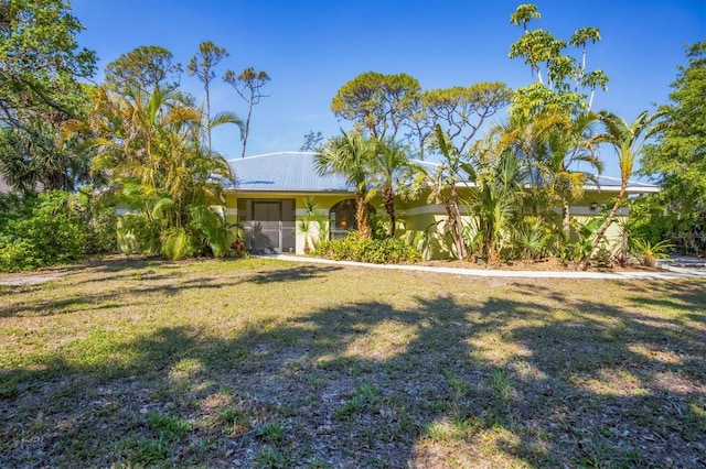 850 Van Gogh Rd, Englewood, FL 34223 - exterior space featuring a front yard and metal roof