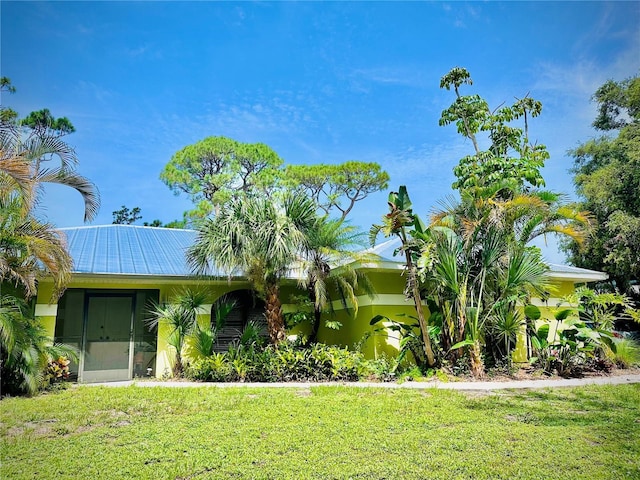 850 Van Gogh Rd, Englewood, FL 34223 - view of front of home with a front lawn and a metal roof