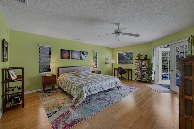 850 Van Gogh Rd, Englewood, FL 34223 - bedroom featuring access to exterior, wood finished floors, a textured ceiling, and ceiling fan