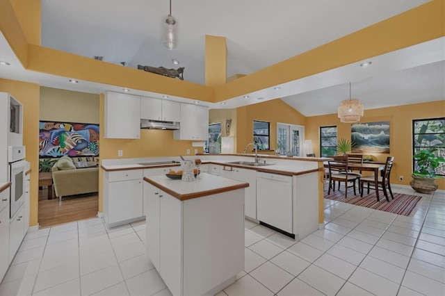 850 Van Gogh Rd, Englewood, FL 34223 - kitchen featuring white appliances, light countertops, under cabinet range hood, a kitchen island, and light tile patterned flooring