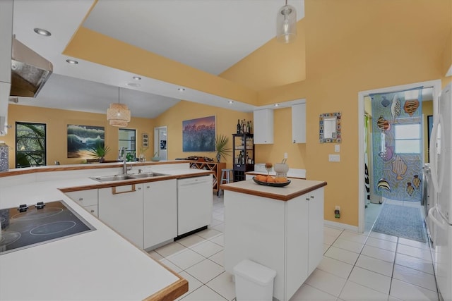 850 Van Gogh Rd, Englewood, FL 34223 - kitchen with dishwasher, black electric cooktop, white cabinets, hanging light fixtures, and wall chimney exhaust hood