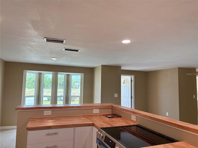 3415 Gulf Ln, Rotonda West, FL 33947 - kitchen featuring butcher block counters, stainless steel electric stove, white cabinets, baseboards, and recessed lighting