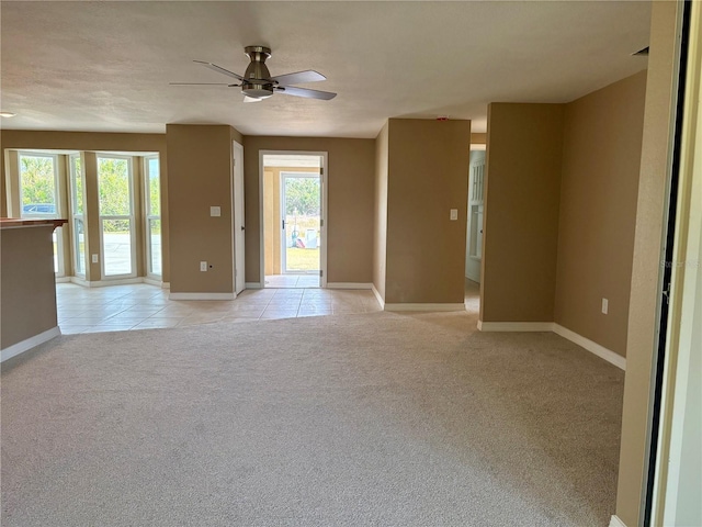 3415 Gulf Ln, Rotonda West, FL 33947 - unfurnished room featuring light carpet, healthy amount of natural light, light tile patterned flooring, and baseboards