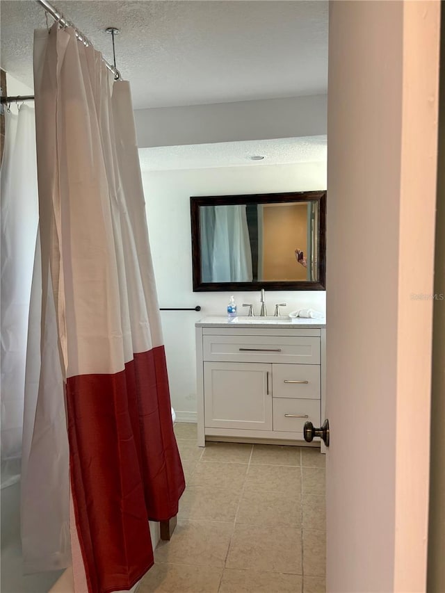 3415 Gulf Ln, Rotonda West, FL 33947 - full bath with vanity, tile patterned flooring, curtained shower, and a textured ceiling