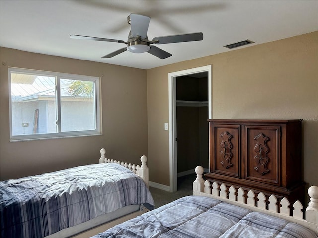 3415 Gulf Ln, Rotonda West, FL 33947 - carpeted bedroom featuring a ceiling fan, baseboards, and a walk in closet
