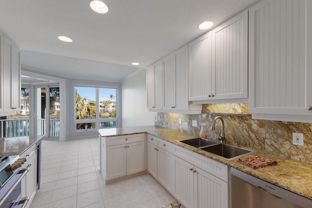 768 Seaboard Line Ln, Boca Grande, FL 33921 - kitchen featuring a sink, stainless steel appliances, light tile patterned flooring, backsplash, and recessed lighting