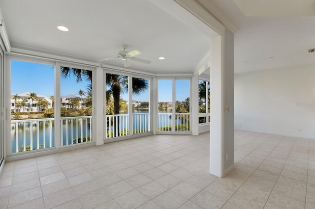 768 Seaboard Line Ln, Boca Grande, FL 33921 - unfurnished sunroom with a water view, plenty of natural light, tile patterned floors, and recessed lighting