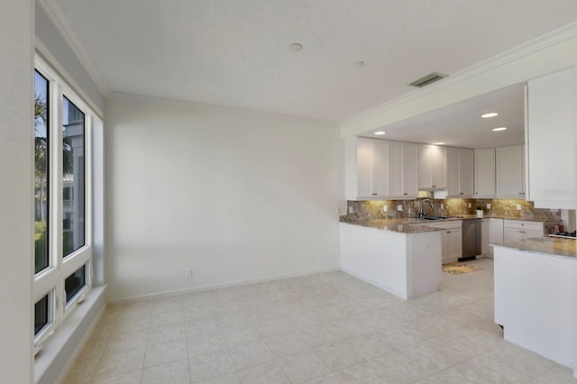 768 Seaboard Line Ln, Boca Grande, FL 33921 - kitchen with a sink, backsplash, stone counters, white cabinets, and a peninsula