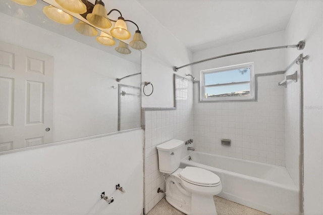 bathroom featuring speckled floor, toilet, shower / bath combination, and tile walls