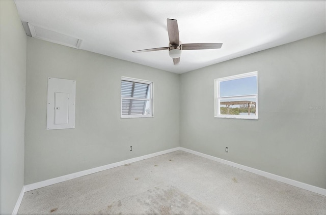 unfurnished room with attic access, electric panel, and baseboards