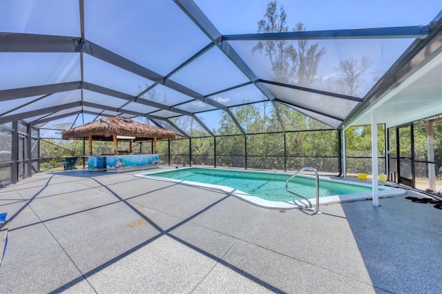 outdoor pool featuring a patio area and a lanai