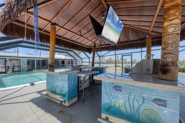 exterior space featuring a lanai, outdoor wet bar, a patio area, and area for grilling