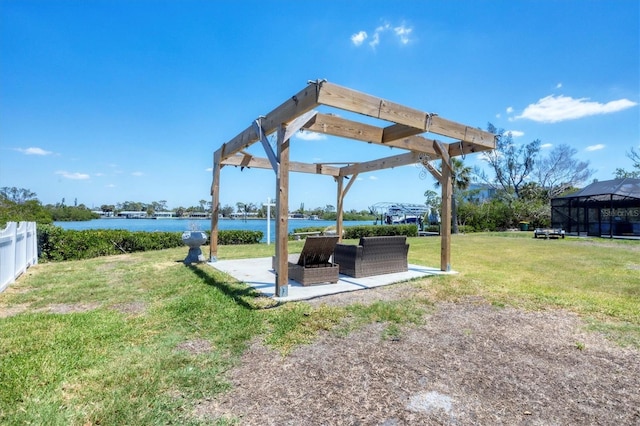view of yard with a pergola, a patio area, a water view, and fence