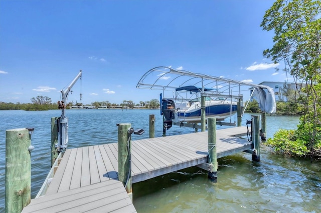 dock area with boat lift and a water view