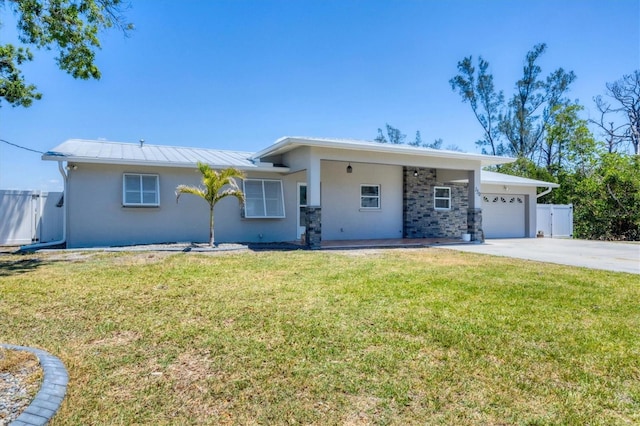ranch-style house with fence, driveway, a front yard, and a garage