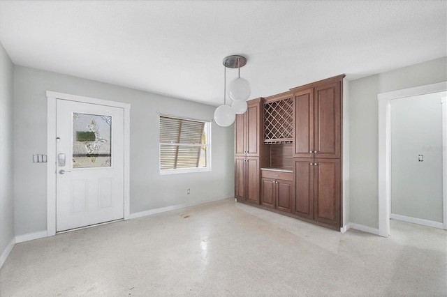 unfurnished dining area with baseboards