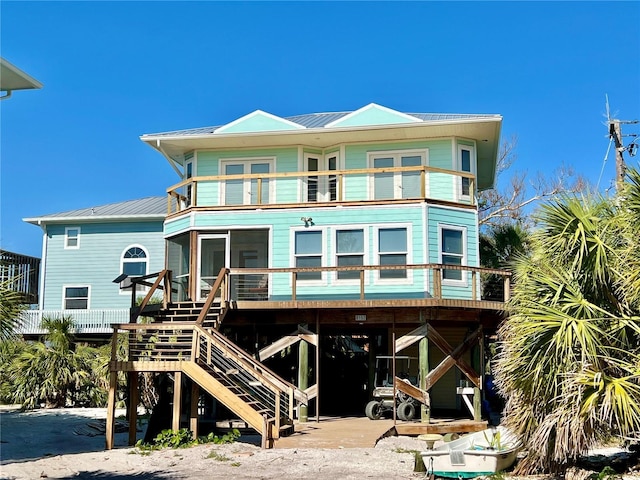 8152 Little Gasparilla Is, Placida, FL 33946 - rear view of house with metal roof, stairs, a carport, and a balcony