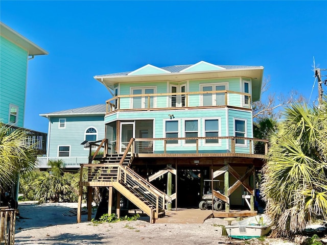 8152 Little Gasparilla Is, Placida, FL 33946 - back of house featuring stairway, a carport, a balcony, and metal roof